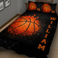 Close bedroom view of a black and orange basketball quilt blanket with matching basketball pillows