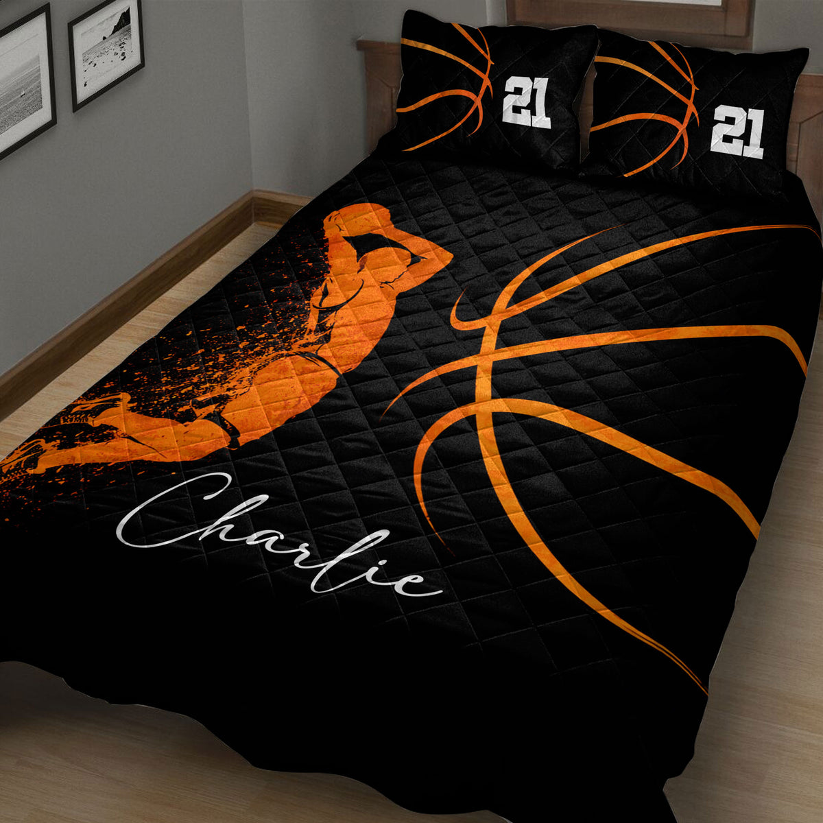 Close bedroom view of a black basketball quilt blanket with orange basketball graphics