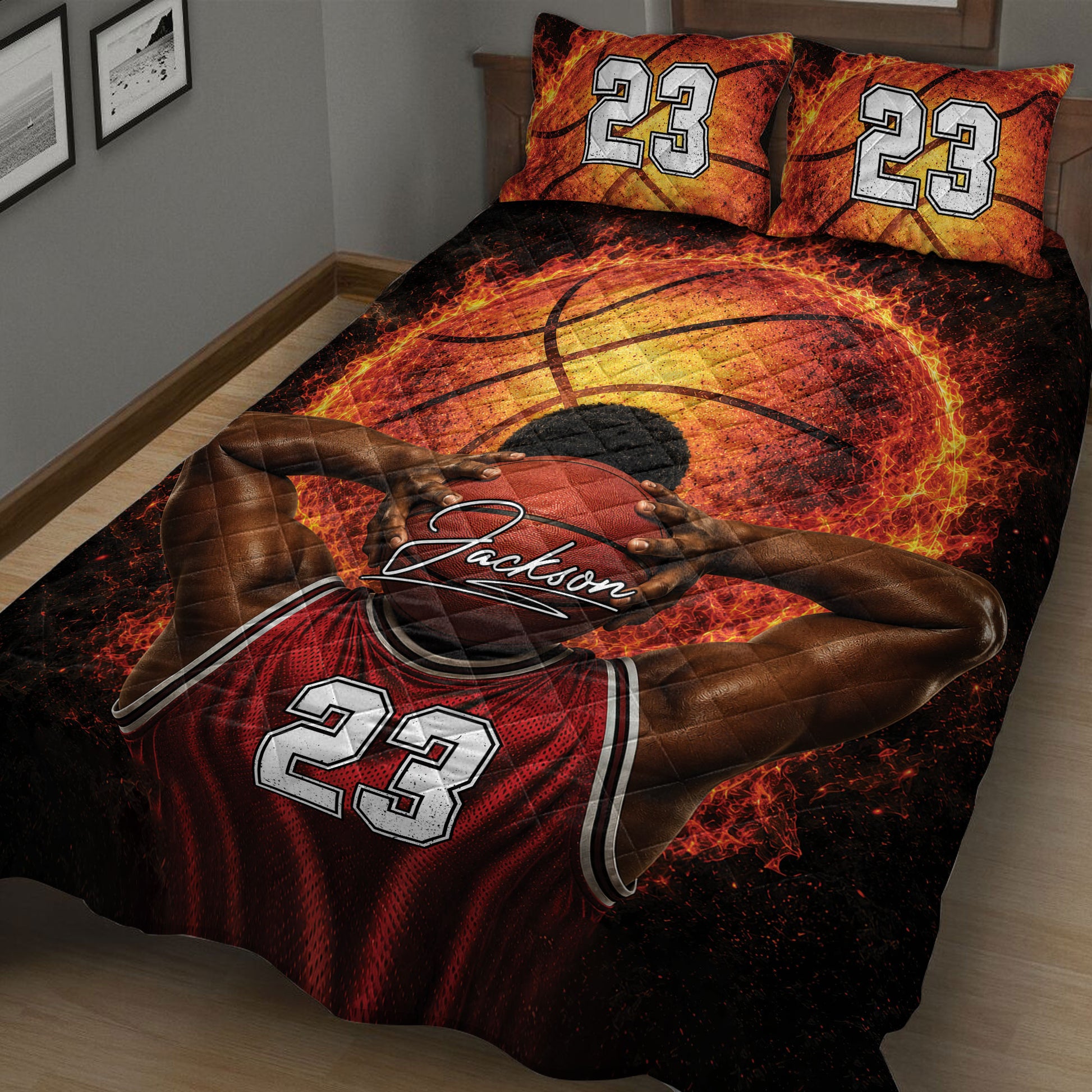 Close bedroom view of a black, red, and orange basketball quilt featuring a dramatic player illustration