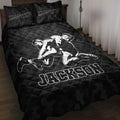 Black wrestling quilt blanket displayed on a bed with grappling artwork and bold sports lettering