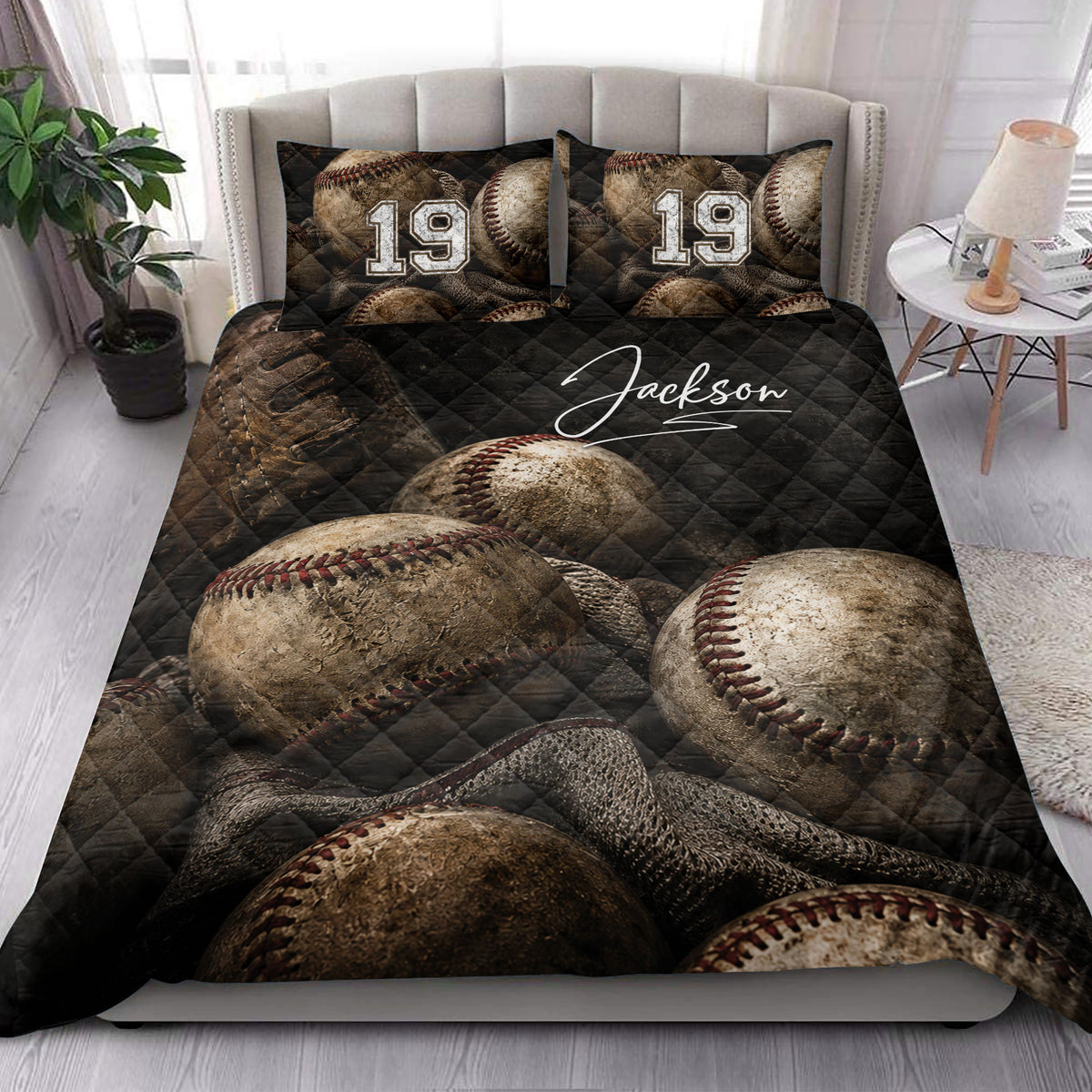 Baseball quilt blanket styled in a bright bedroom with vintage baseball artwork and dark quilted texture