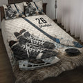 Hockey quilt blanket displayed on a bed with skates, sticks, pucks, and blue sports accents