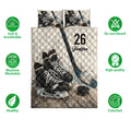 Hockey quilt bedding set showing skates, sticks, pucks, and a bold black, white, and blue design