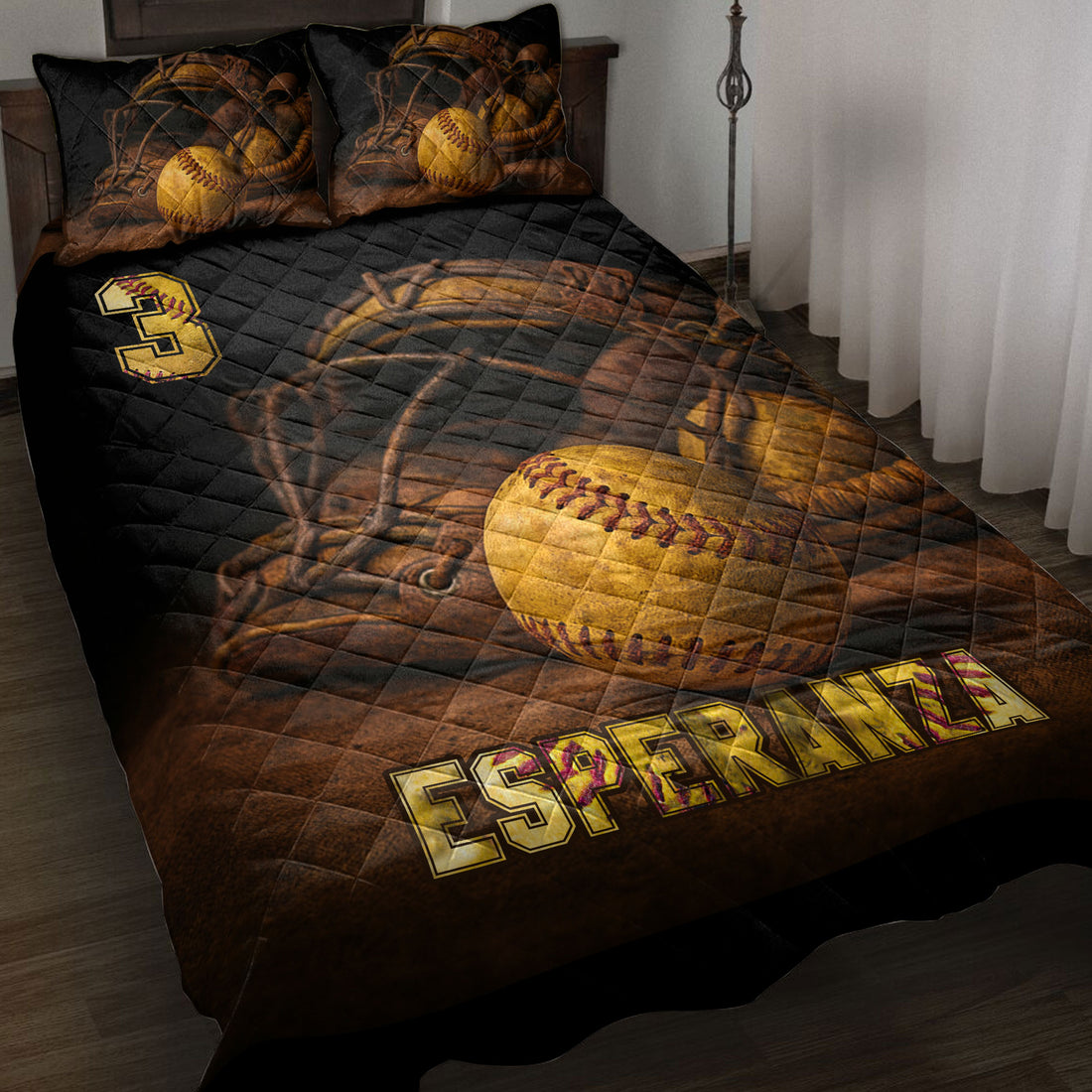 Softball quilt blanket displayed on a bed with vintage gloves, yellow softballs, and black and gold sports artwork