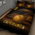 Close bedroom view of a softball quilt blanket featuring vintage glove and ball artwork in warm gold tones