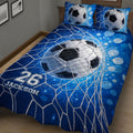 Soccer quilt bedding displayed on a bed with blue goal net graphics and ball design