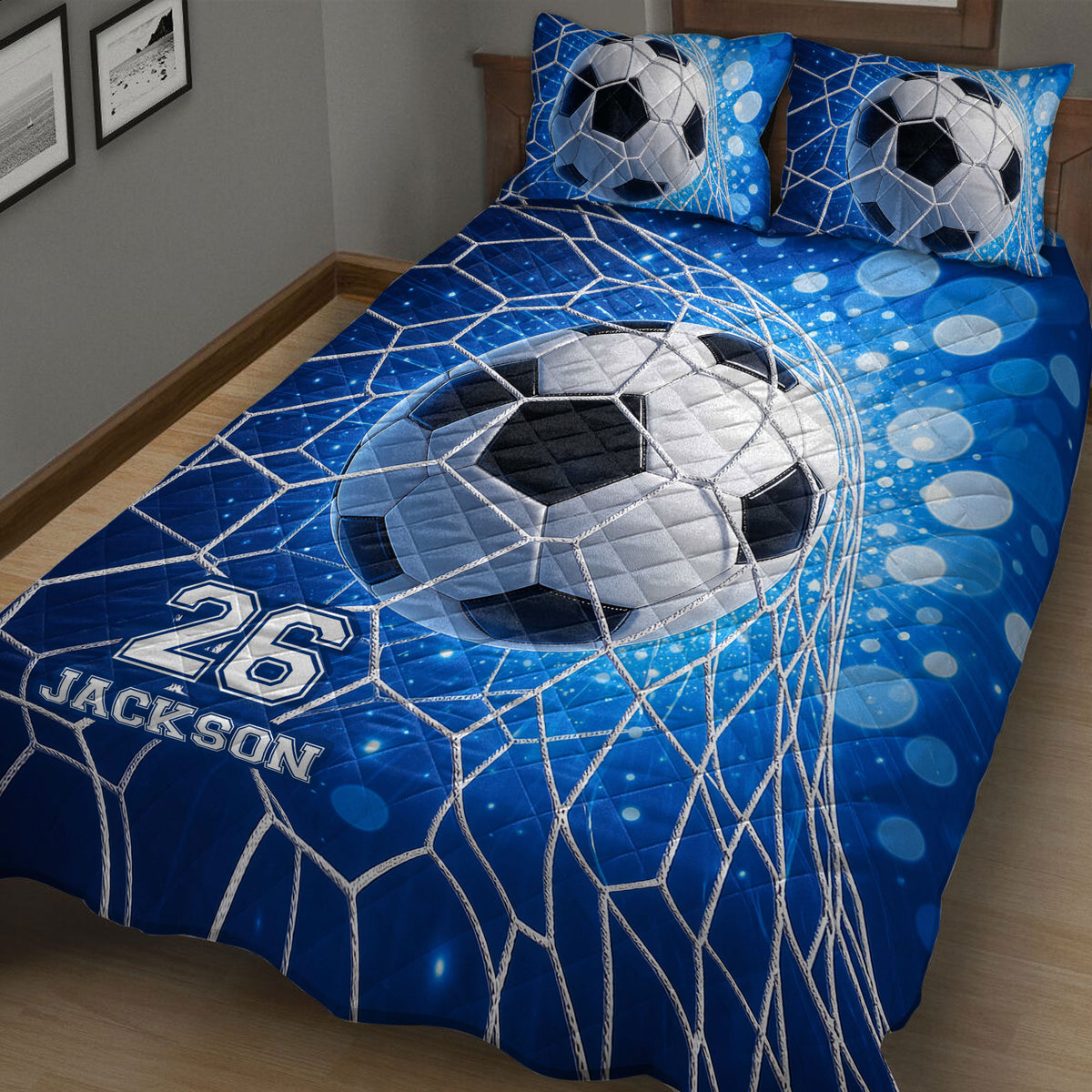 Soccer quilt bedding displayed on a bed with blue goal net graphics and ball design