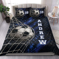 Soccer quilt blanket styled on a bedroom bed with dramatic blue and black sports artwork