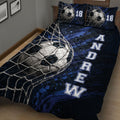 Close view of soccer ball and goal net artwork across a dark blue quilt blanket