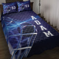 Blue hockey quilt blanket styled on a bed with helmet artwork, bold rink-inspired graphics, and pillow options