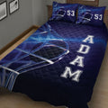 Close bedroom view of a navy hockey quilt blanket with helmet artwork and dynamic blue rink-inspired lines
