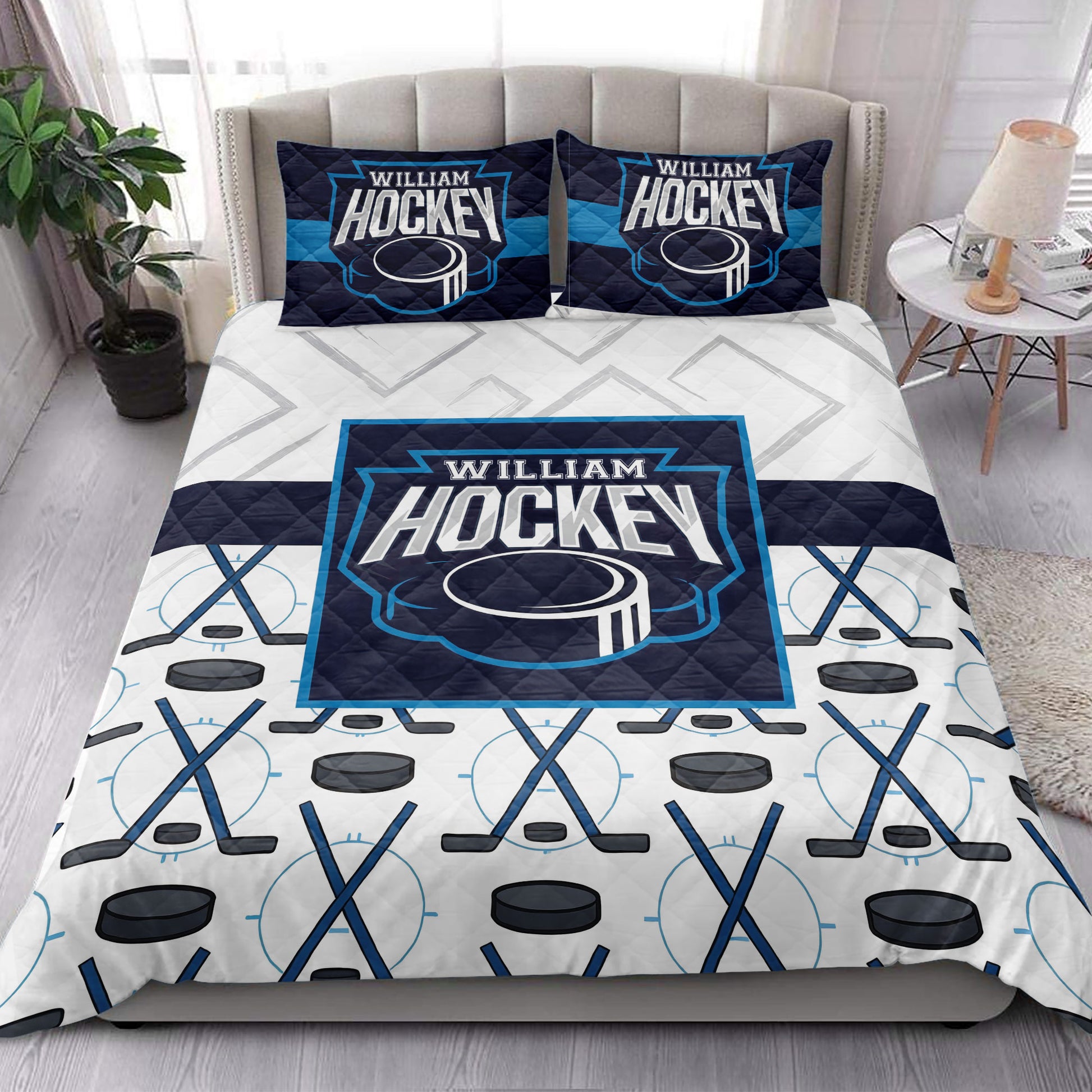 Hockey quilt bedding styled in a modern bedroom with bold navy, cyan, and white stick and puck graphics
