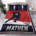Hockey quilt bedding styled in a bedroom with skating player artwork, red and navy rink-inspired accents