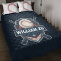 Navy baseball quilt blanket displayed on a bed with crossed bats, stars, and coordinating baseball pillow designs