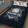 Close-up view of a navy baseball quilt blanket with crossed bats, star accents, and bold sports artwork