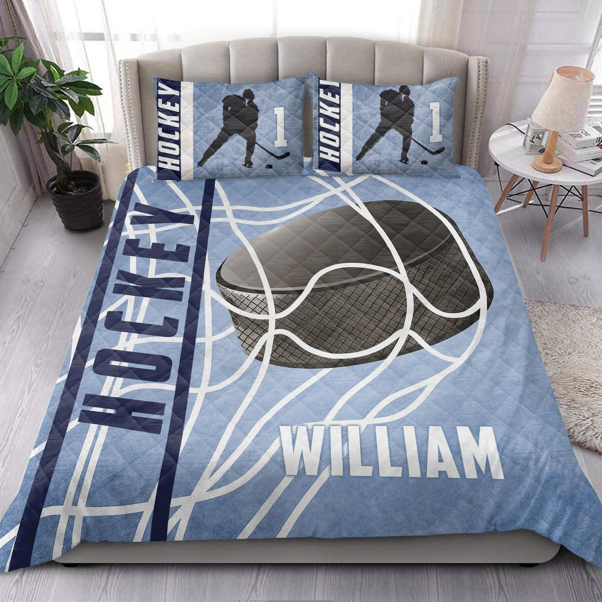 Hockey quilt blanket presented in a bright bedroom with blue rink graphics, hockey player silhouettes, and bold sports artwork