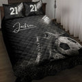 Black soccer quilt blanket displayed on a bed with stadium lights, cleats, and soccer ball artwork