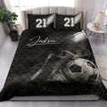 Soccer quilt bedding styled on a bedroom bed with cleats, soccer ball, and stadium light artwork