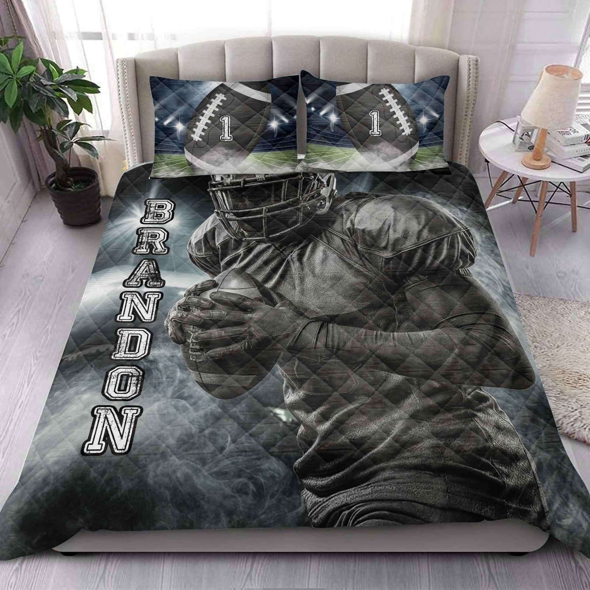 Football quilt blanket styled on a bedroom bed with helmeted player artwork and stadium-themed pillows