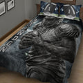 Close bedroom view of a football quilt blanket featuring a helmeted player holding a football