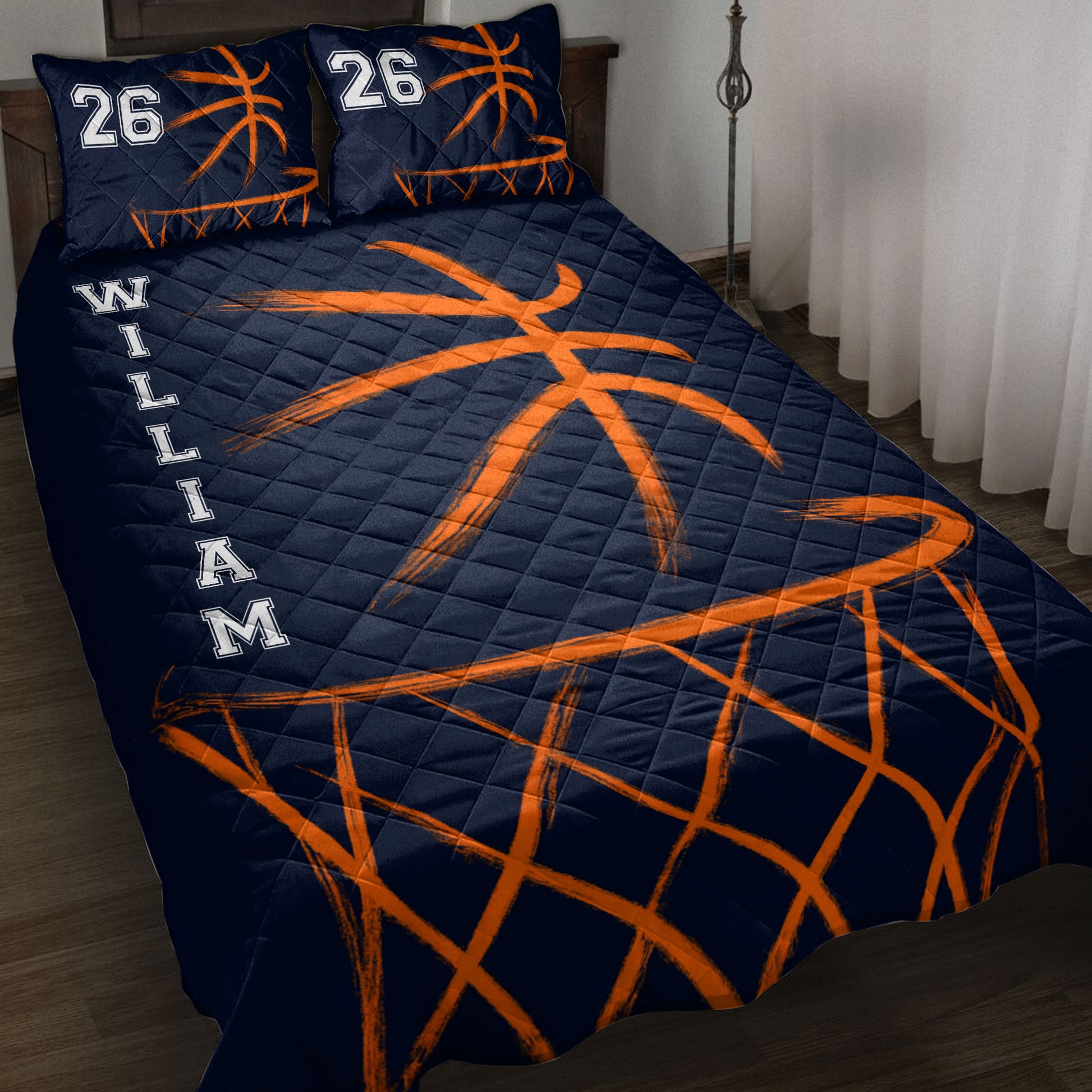 Navy basketball quilt blanket with bold orange basketball and hoop artwork displayed on a bed