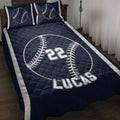 Navy baseball quilt blanket displayed on a bed with baseball artwork and bold sports-style design