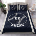Navy baseball quilt blanket styled in a bright bedroom with matching baseball pillow designs