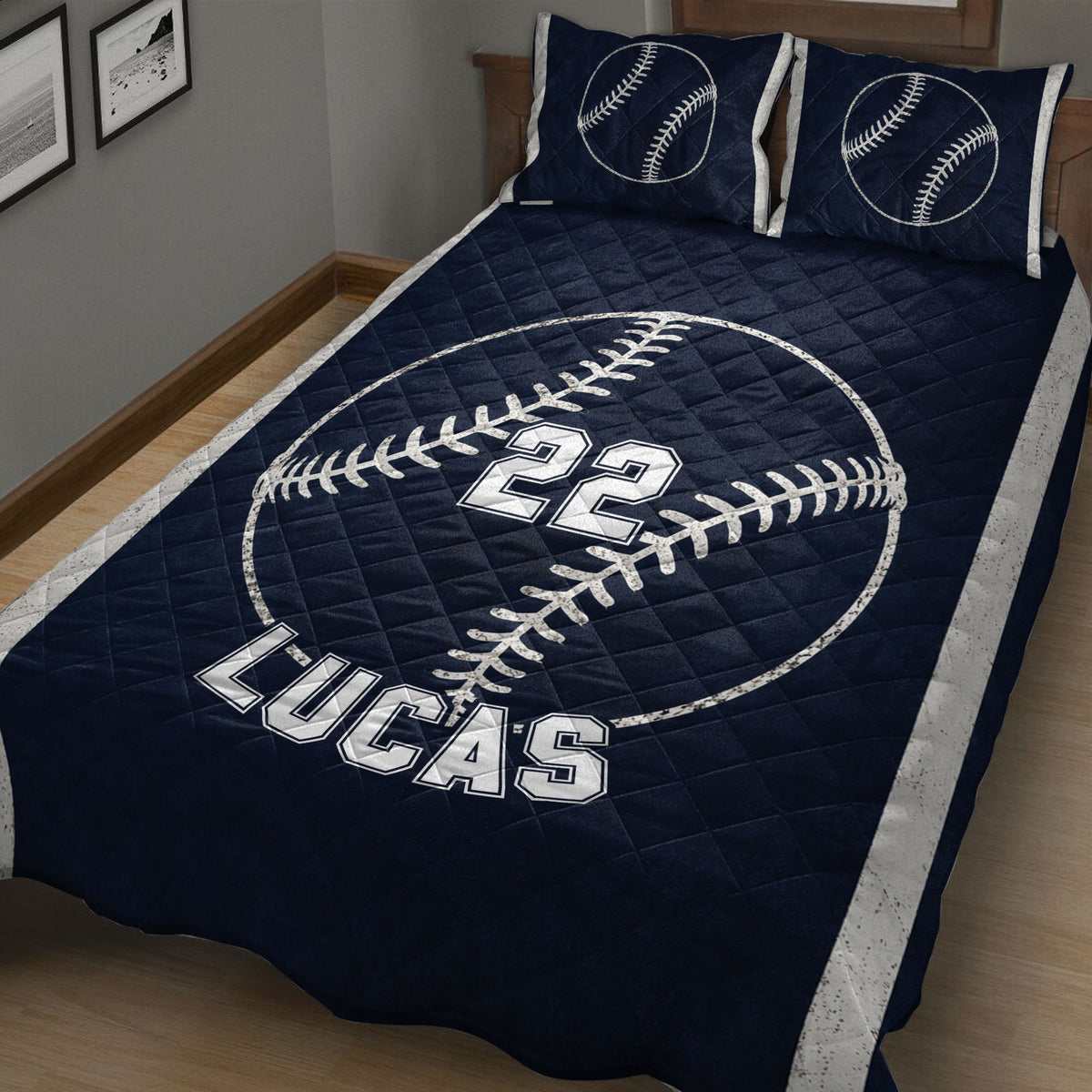 Close bedroom view of a navy baseball quilt with large baseball artwork and bold athletic styling