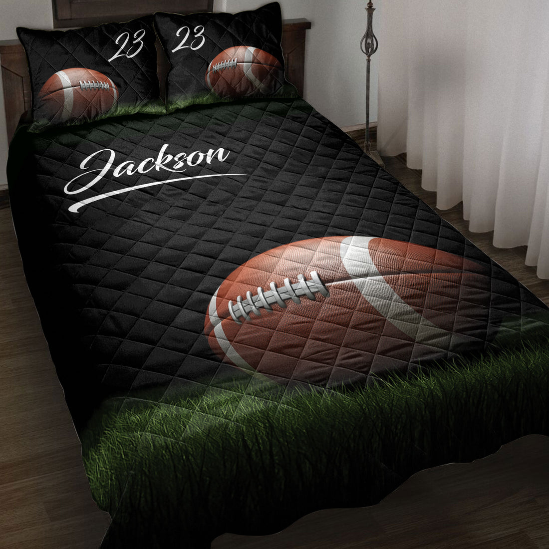 Black football quilt bedding set displayed on a bed with grass field artwork and bold sports design