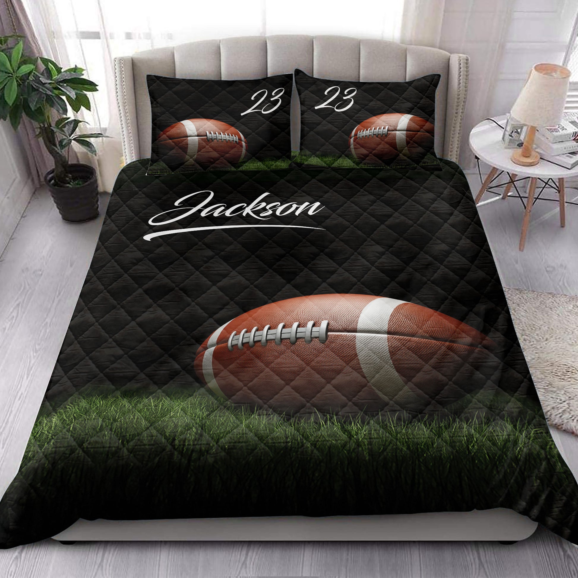American football quilt blanket styled on a bed with black diamond quilting and vivid field artwork