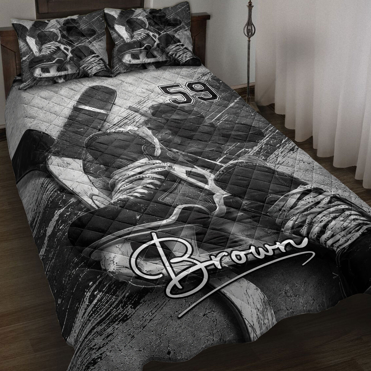 Hockey quilt blanket displayed on a bed with skates, sticks, pucks, and bold black and white sports artwork