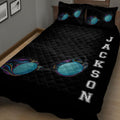 Close bedroom view of a black swimming quilt blanket featuring colorful goggles and sports-inspired artwork