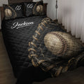 Black baseball quilt blanket displayed on a bed with baseball glove and ball artwork