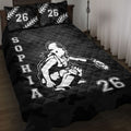 Black softball quilt blanket displayed on a bed with female batter artwork and bold sports graphics