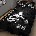 Close bedroom view of black softball quilt blanket featuring a female batter and camouflage background