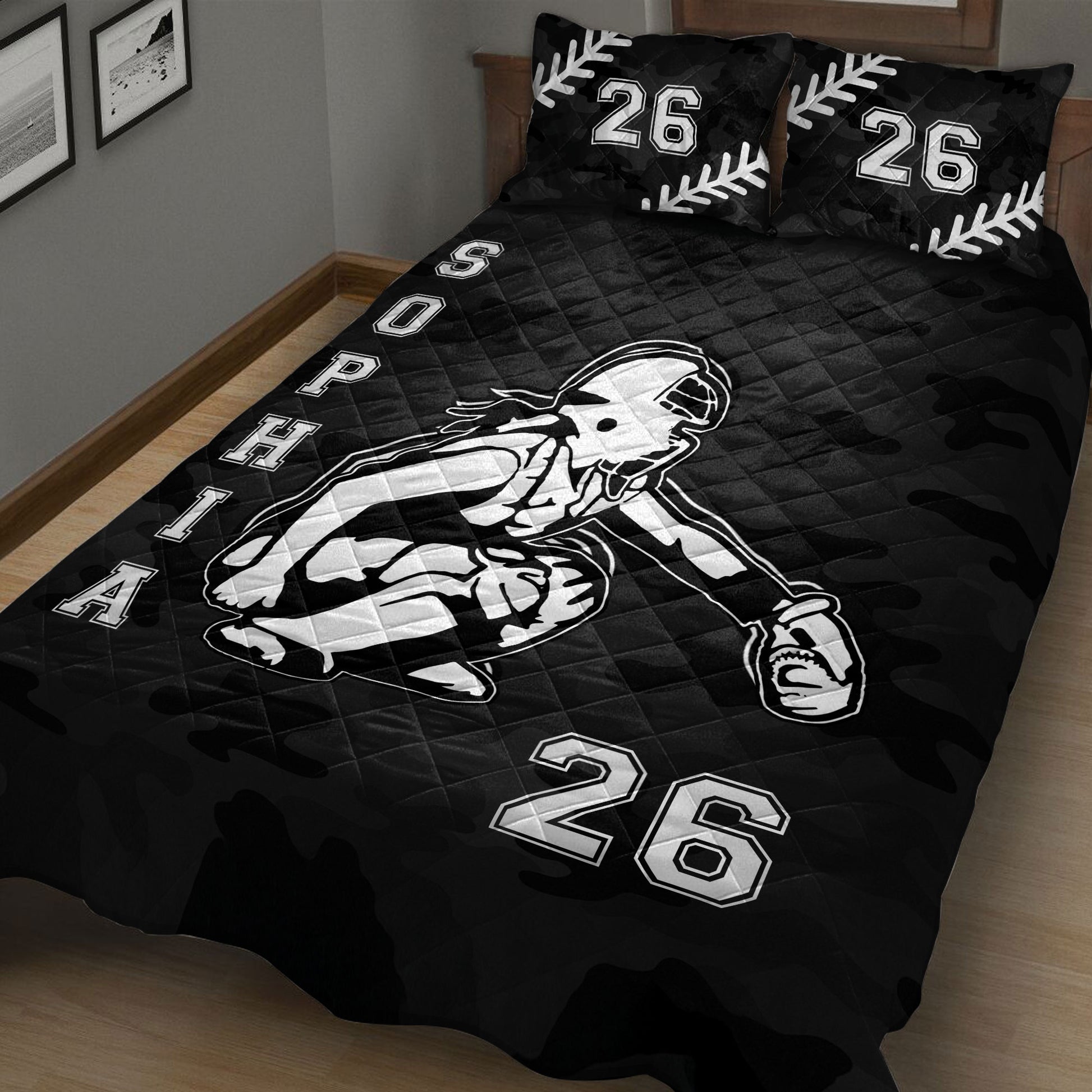 Close bedroom view of black softball quilt blanket featuring a female batter and camouflage background