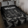 Black and white chess quilt blanket displayed on a bed with matching checkerboard pillow covers
