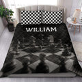 Chess-themed quilt blanket styled on a bedroom bed with checkerboard pillow covers
