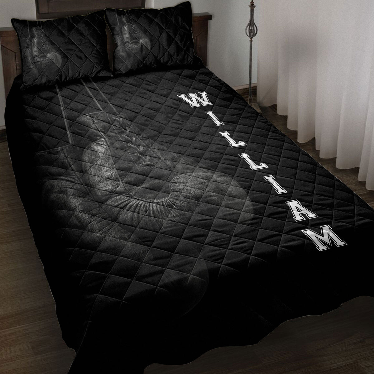 Black boxing quilt blanket displayed on a bed with detailed boxing glove artwork