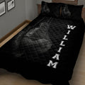 Angled bedroom view of a black boxing quilt blanket with large glove artwork