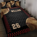 Black baseball quilt blanket displayed on a bed with baseball pillows, red stitching borders, and bold sports artwork