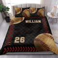 Baseball quilt blanket styled in a bright bedroom with baseball pillows, black bedding, and red stitching accents