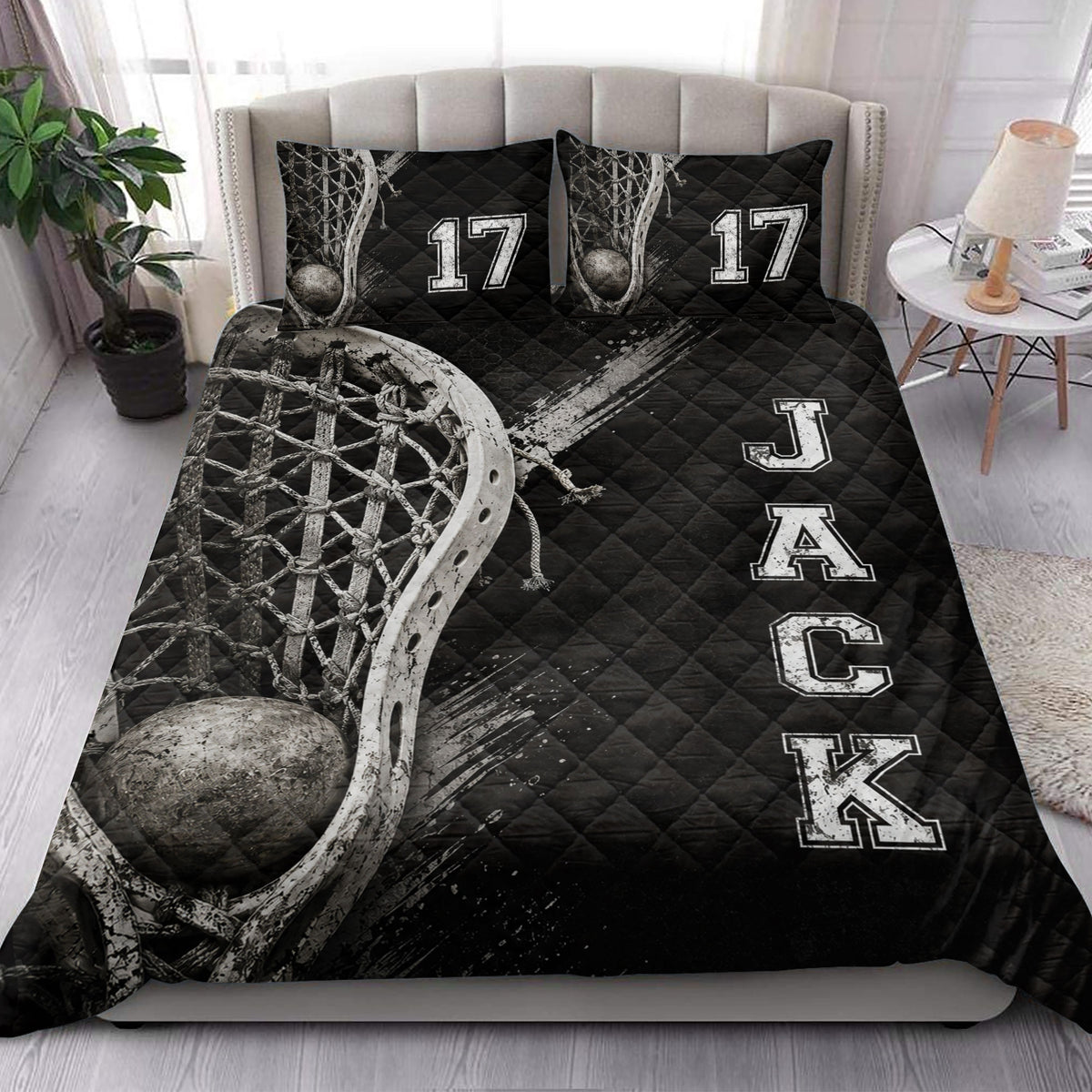 Lacrosse quilt blanket styled in a bright bedroom with black athletic artwork and lacrosse equipment imagery