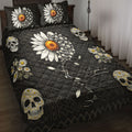 Skull quilt blanket displayed on a bed with daisies, orange flowers, geometric patterns, and black gothic artwork
