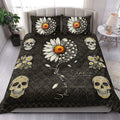 Gothic skull quilt blanket styled on a bedroom bed with daisy-covered skulls and dark geometric patterns
