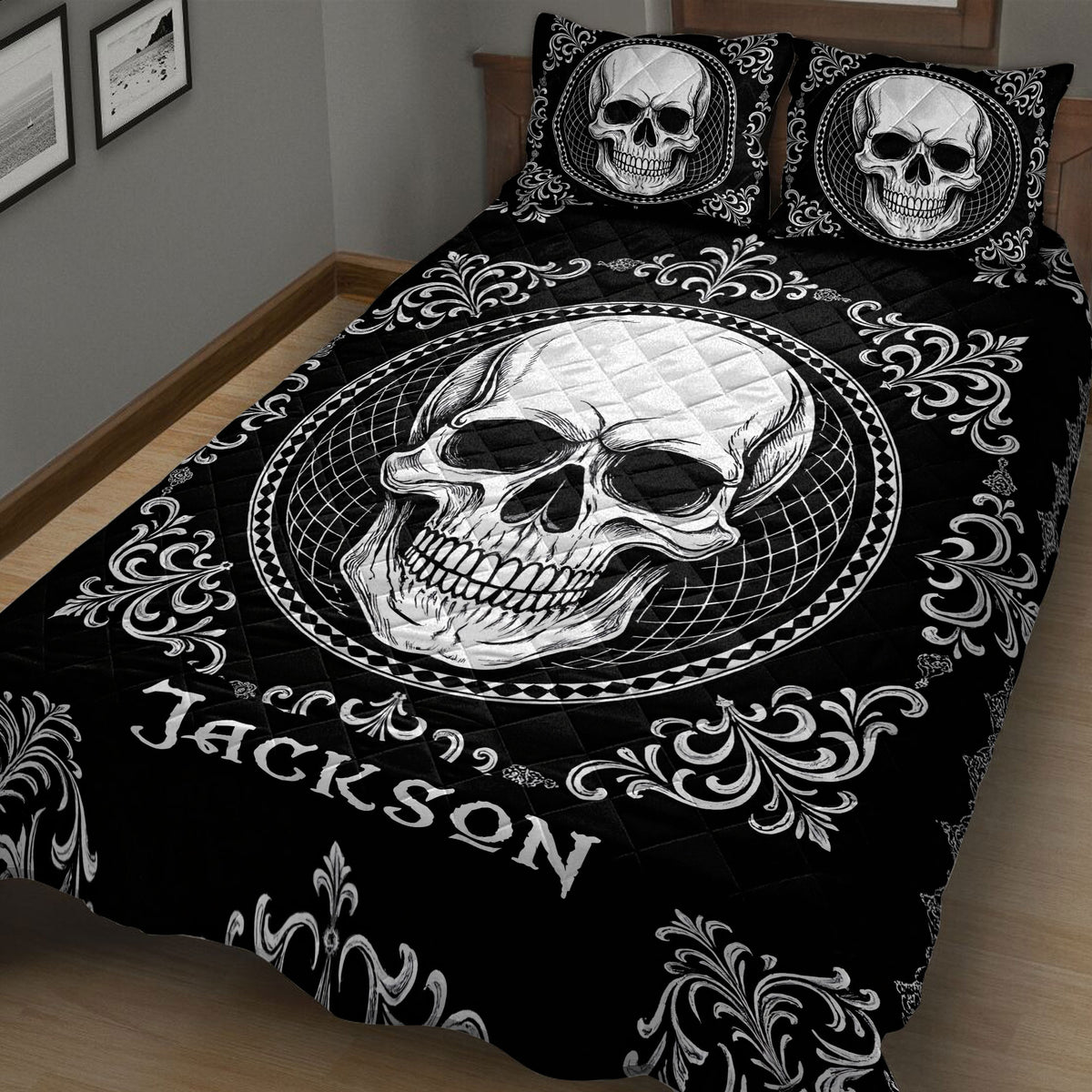 Angled bedroom view of a black skull quilt blanket with a large central skull medallion