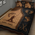 Close bedroom view of a fishing quilt blanket featuring bass, an angler silhouette, fish hooks, and heart artwork