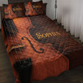 Rustic cello quilt blanket in rich brown and copper tones displayed on a bedroom bed