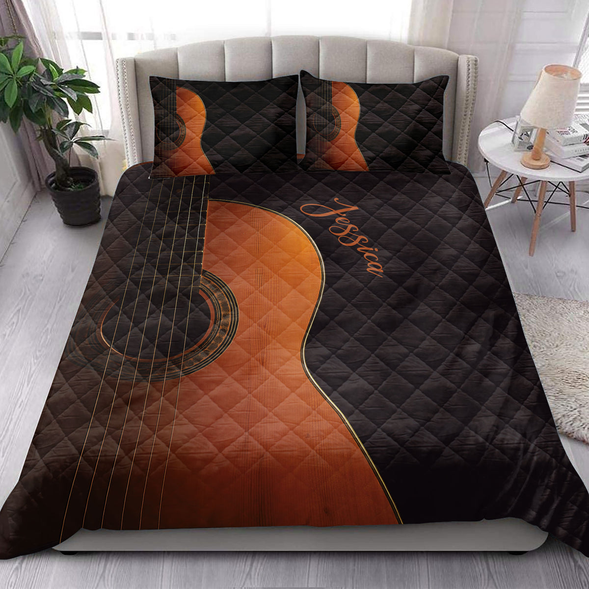 Black guitar quilt blanket arranged on a bed in a bright bedroom with coordinating guitar pillows