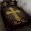 Black Christian cross quilt blanket with ornate gold artwork styled on a bedroom bed